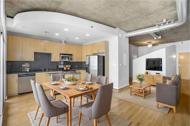 dining area with recessed lighting and light wood-style floors