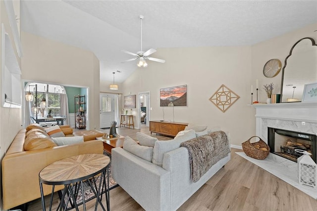 1865 Morgans Run Trl, Buford, GA 30519 - living room with wood finished floors, a premium fireplace, ceiling fan, high vaulted ceiling, and baseboards