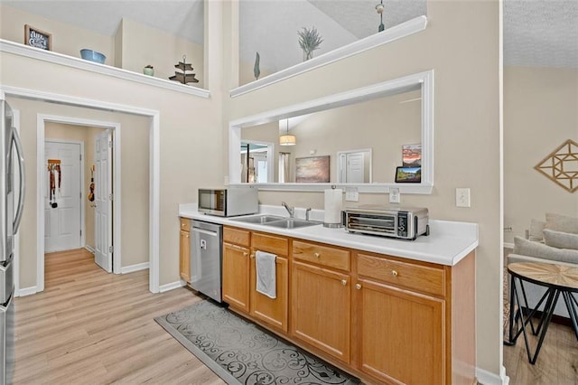 1865 Morgans Run Trl, Buford, GA 30519 - kitchen featuring stainless steel appliances, a sink, light wood-style floors, light countertops, and baseboards