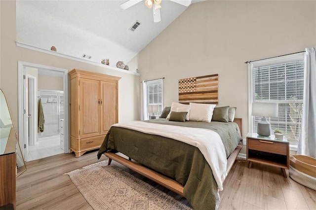1865 Morgans Run Trl, Buford, GA 30519 - bedroom with high vaulted ceiling, light wood-type flooring, a ceiling fan, and ensuite bath