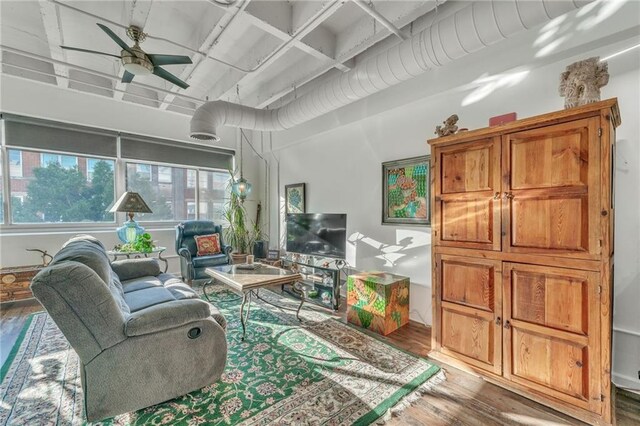 living room featuring ceiling fan and hardwood / wood-style flooring