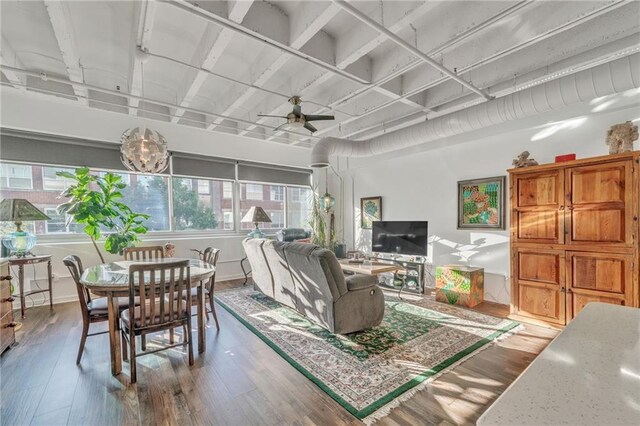 living room featuring ceiling fan and hardwood / wood-style flooring