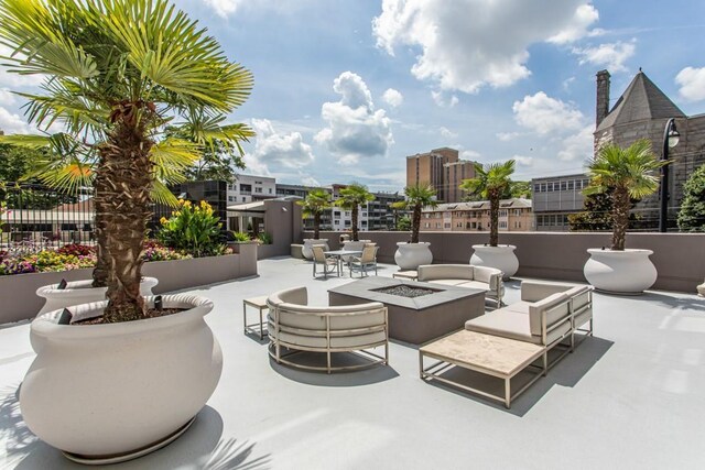 view of patio / terrace with an outdoor living space with a fire pit