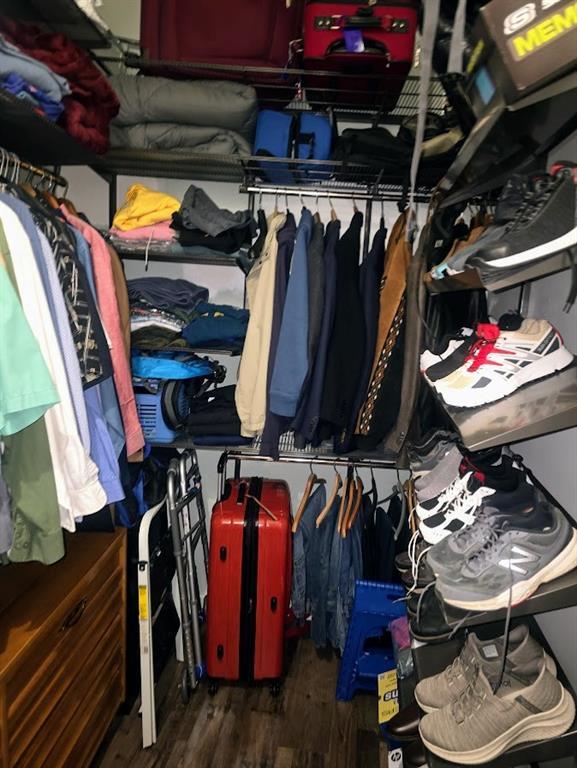 spacious closet featuring dark hardwood / wood-style floors