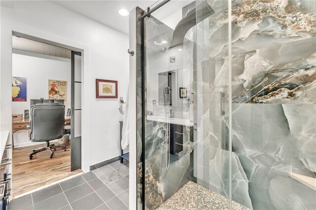 bathroom featuring tile patterned flooring and a shower with shower door