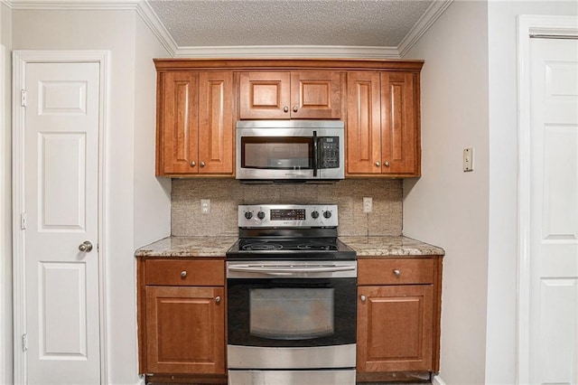 kitchen featuring backsplash, light stone countertops, stainless steel appliances, and ornamental molding