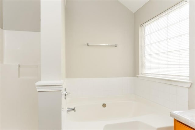 bathroom featuring a washtub and vanity