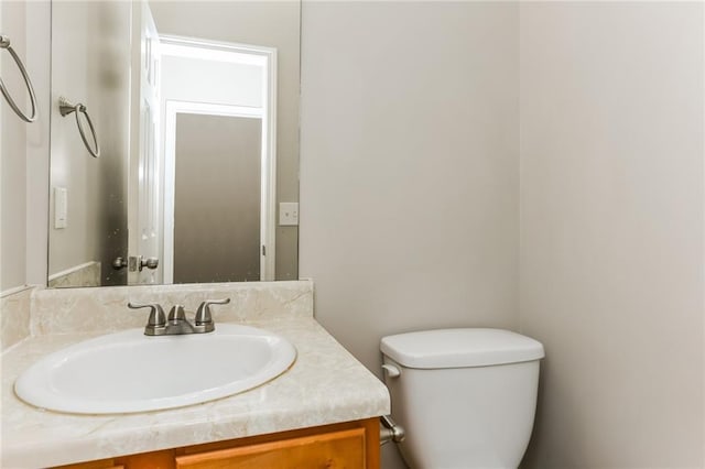 bathroom with toilet and vanity