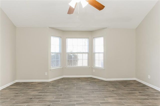 empty room with ceiling fan and light hardwood / wood-style flooring