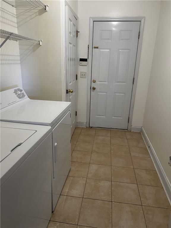 5026 Limerick Ln, Flowery Branch, GA 30542 - washroom with independent washer and dryer and light tile patterned floors