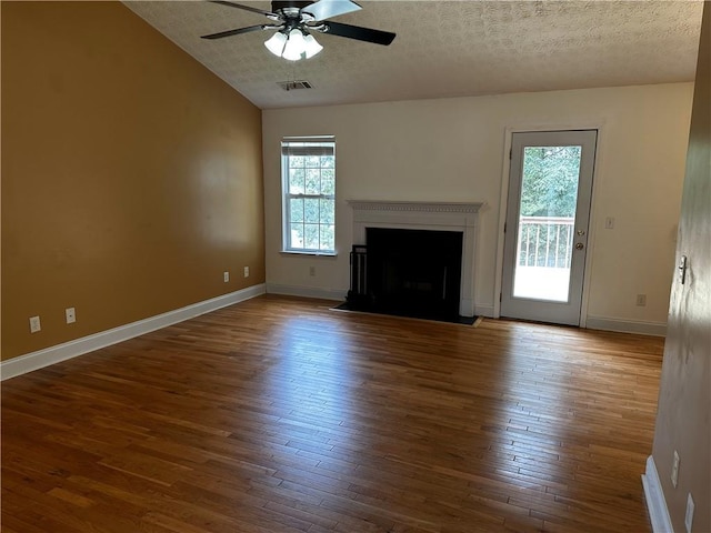 5026 Limerick Ln, Flowery Branch, GA 30542 - unfurnished living room with lofted ceiling, a ceiling fan, wood finished floors, a textured ceiling, and a fireplace with flush hearth