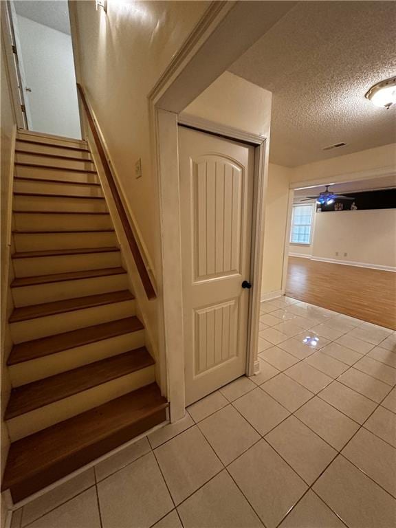 5026 Limerick Ln, Flowery Branch, GA 30542 - stairway featuring tile patterned flooring and a textured ceiling
