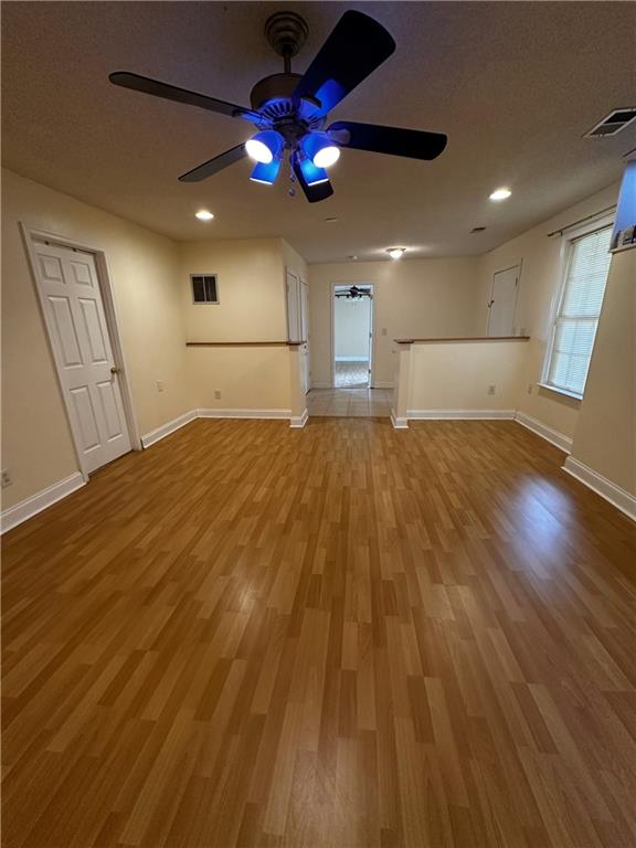 5026 Limerick Ln, Flowery Branch, GA 30542 - unfurnished living room with ceiling fan, wood finished floors, and recessed lighting