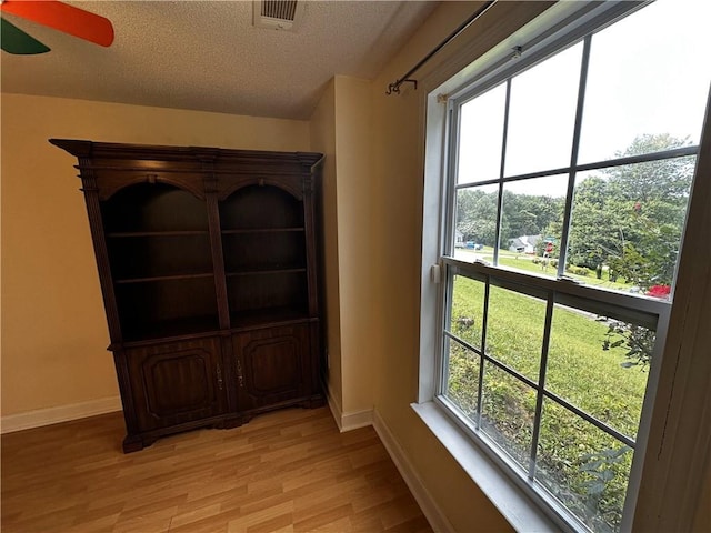 5026 Limerick Ln, Flowery Branch, GA 30542 - detailed view of wood finished floors, a textured ceiling, and ceiling fan