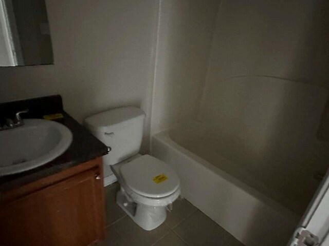 bathroom with tile patterned floors, vanity, and toilet