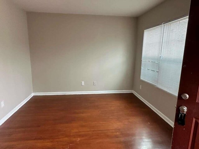 empty room featuring dark hardwood / wood-style floors