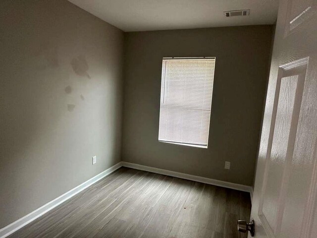 empty room with hardwood / wood-style flooring