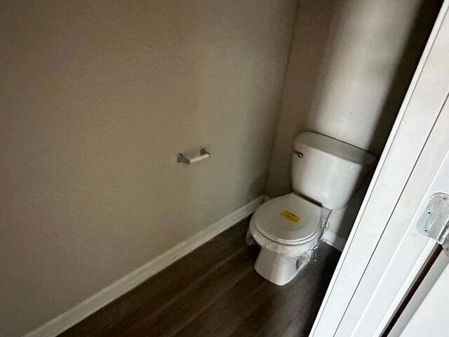 bathroom featuring hardwood / wood-style floors and toilet