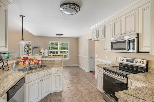 208 Stonington Dr, Mount Airy, GA 30563 - kitchen featuring appliances with stainless steel finishes, a sink, light countertops, cream cabinets, and decorative light fixtures