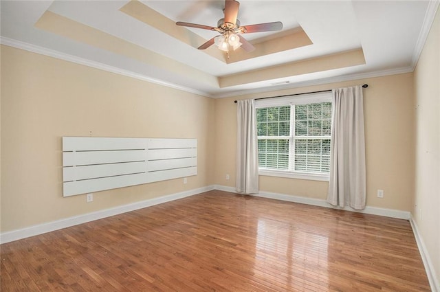 208 Stonington Dr, Mount Airy, GA 30563 - spare room featuring a raised ceiling, wood finished floors, a ceiling fan, and ornamental molding