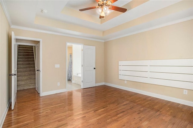 208 Stonington Dr, Mount Airy, GA 30563 - empty room with wood finished floors, ceiling fan, a raised ceiling, a smoke detector, and baseboards