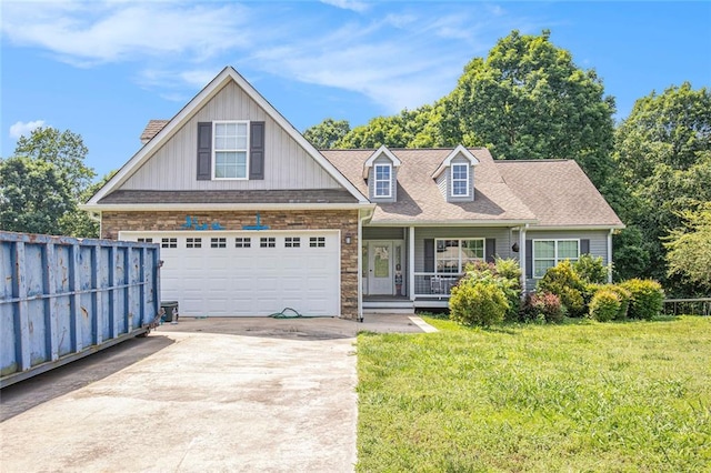 208 Stonington Dr, Mount Airy, GA 30563 - view of front facade with a porch, driveway, board and batten siding, a garage, and stone siding