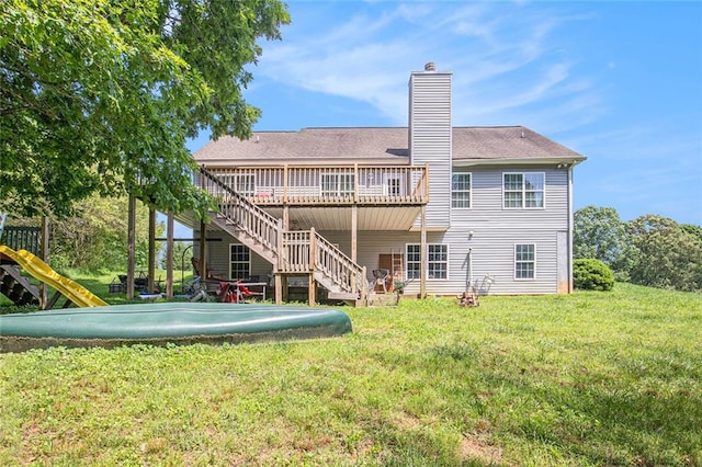 208 Stonington Dr, Mount Airy, GA 30563 - back of property with a chimney, stairs, a wooden deck, a lawn, and roof with shingles