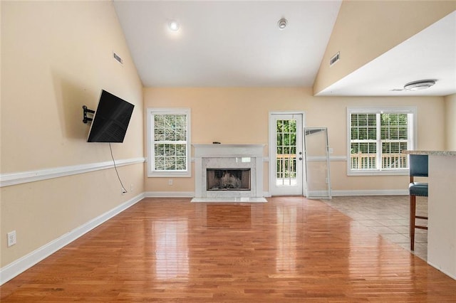 208 Stonington Dr, Mount Airy, GA 30563 - unfurnished living room featuring a premium fireplace, baseboards, wood finished floors, and high vaulted ceiling