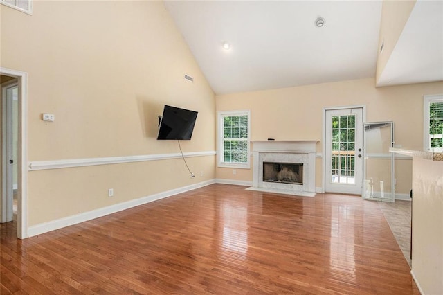 208 Stonington Dr, Mount Airy, GA 30563 - unfurnished living room featuring high vaulted ceiling, wood finished floors, a fireplace, and baseboards