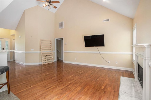 208 Stonington Dr, Mount Airy, GA 30563 - unfurnished living room with high vaulted ceiling, ceiling fan, wood finished floors, a fireplace with flush hearth, and baseboards