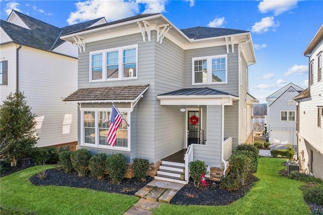 view of front of house featuring a garage and a front lawn