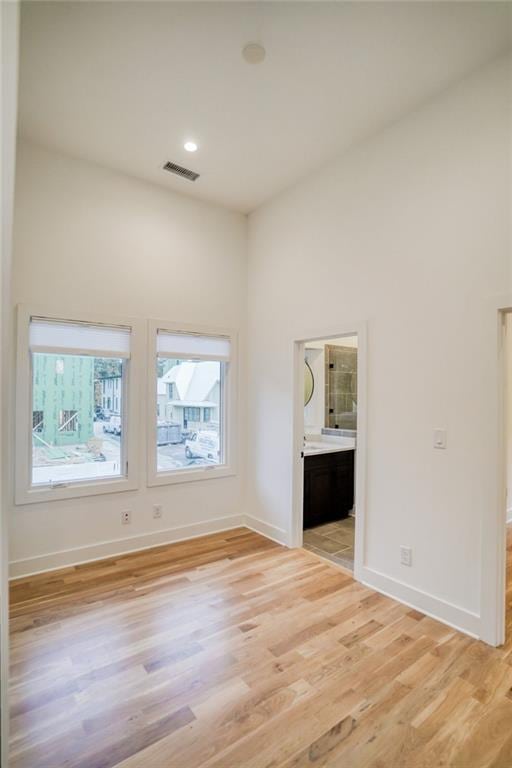 empty room with recessed lighting, baseboards, visible vents, and light wood-type flooring