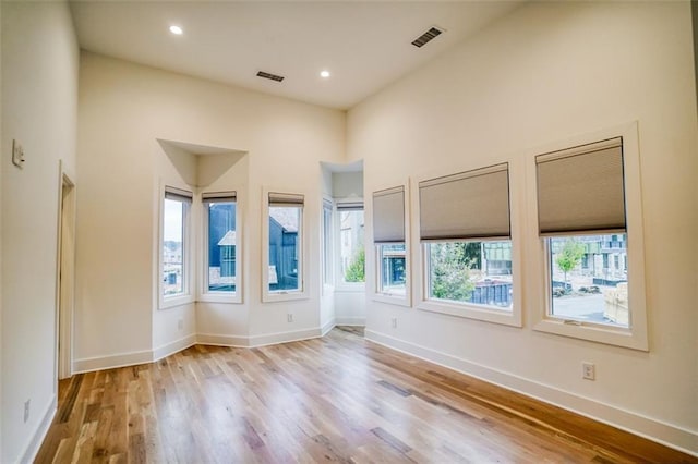 unfurnished room featuring visible vents, recessed lighting, baseboards, and wood finished floors