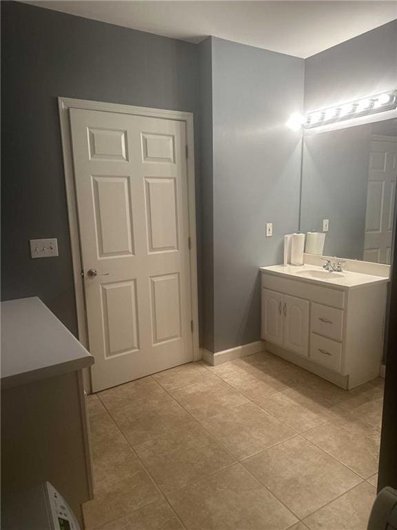 bathroom featuring vanity, baseboards, and tile patterned floors