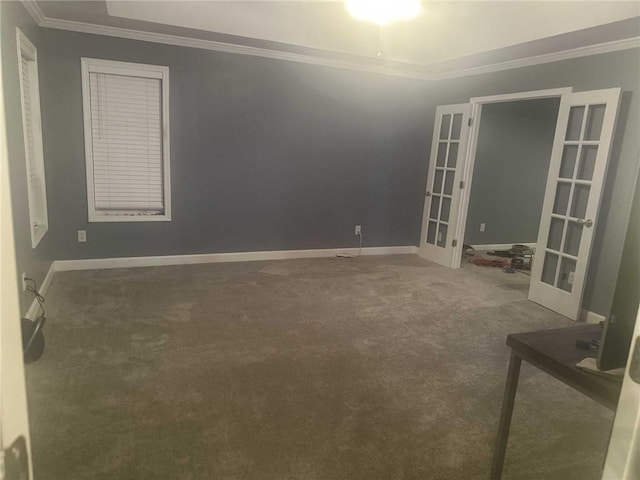 carpeted spare room featuring baseboards, french doors, and crown molding