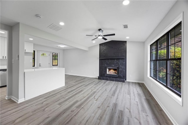 2246 Hightrail Ct, Lithonia, GA 30058 - unfurnished living room with a ceiling fan, wood finished floors, recessed lighting, vaulted ceiling, and a premium fireplace