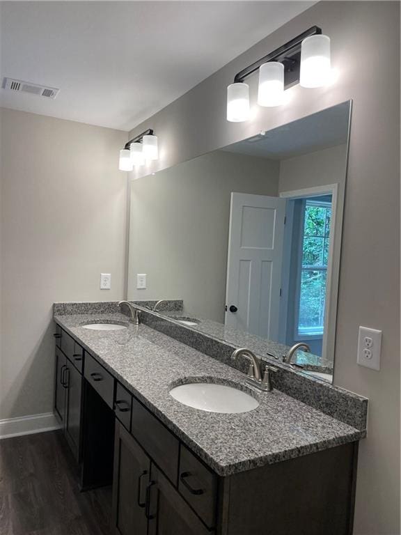 bathroom with vanity and hardwood / wood-style flooring