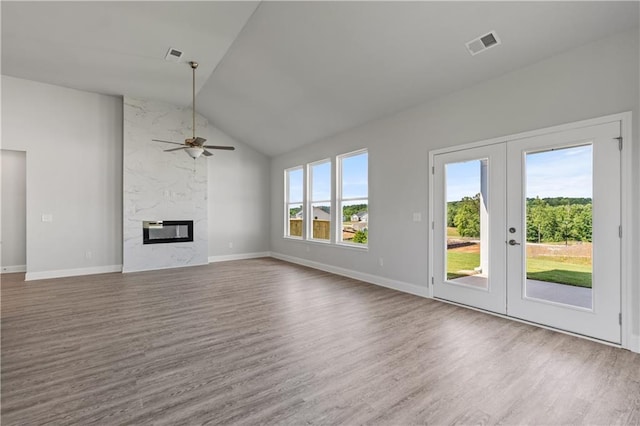 unfurnished living room with a healthy amount of sunlight and wood-type flooring