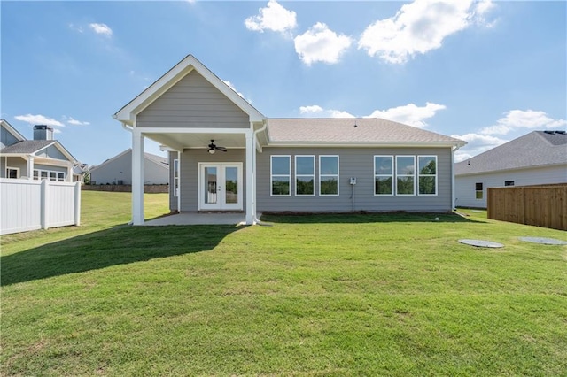 back of house with ceiling fan, french doors, a yard, and a patio