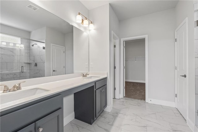 bathroom featuring an enclosed shower and vanity