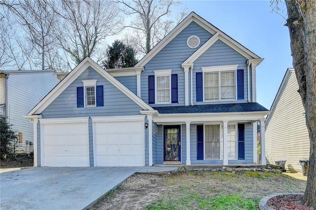 traditional-style home with a garage, concrete driveway, and covered porch