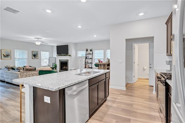 4658 Electric Ave SW, Mableton, GA 30126 - kitchen with dark brown cabinetry, visible vents, appliances with stainless steel finishes, a sink, and light wood-style floors