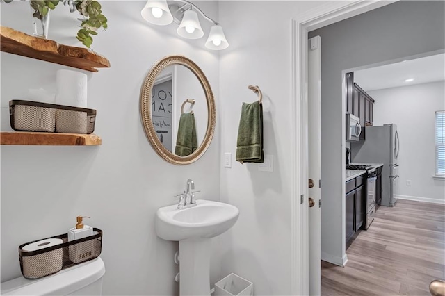4658 Electric Ave SW, Mableton, GA 30126 - bathroom featuring baseboards, wood finished floors, and toilet
