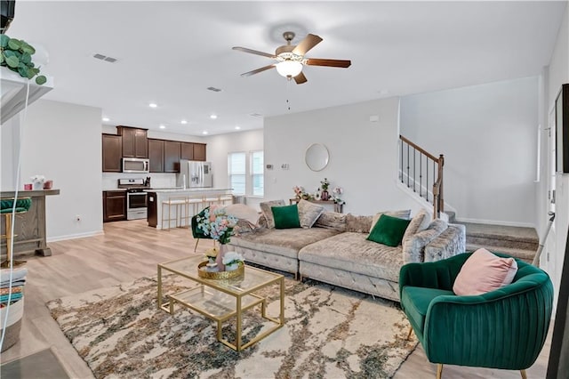 4658 Electric Ave SW, Mableton, GA 30126 - living area featuring ceiling fan, recessed lighting, light wood-type flooring, visible vents, and stairway
