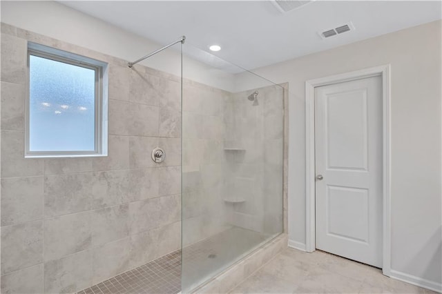 4658 Electric Ave SW, Mableton, GA 30126 - bathroom with baseboards, tile patterned flooring, tiled shower, and visible vents