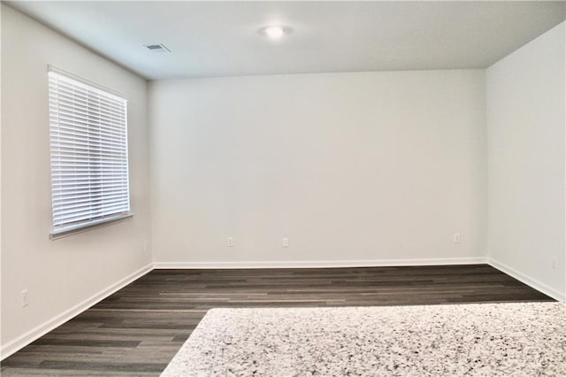 unfurnished room featuring dark wood-type flooring