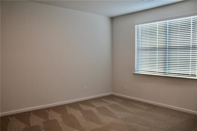 carpeted empty room with plenty of natural light