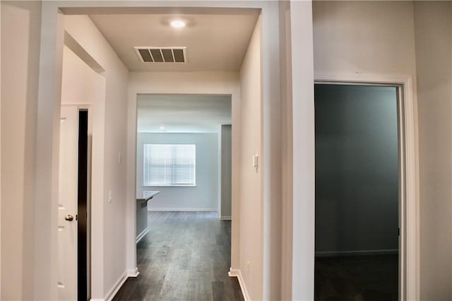 hallway with dark hardwood / wood-style flooring