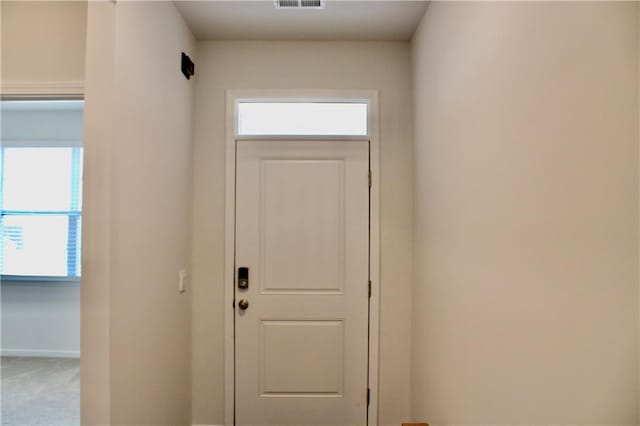 doorway to outside featuring carpet floors