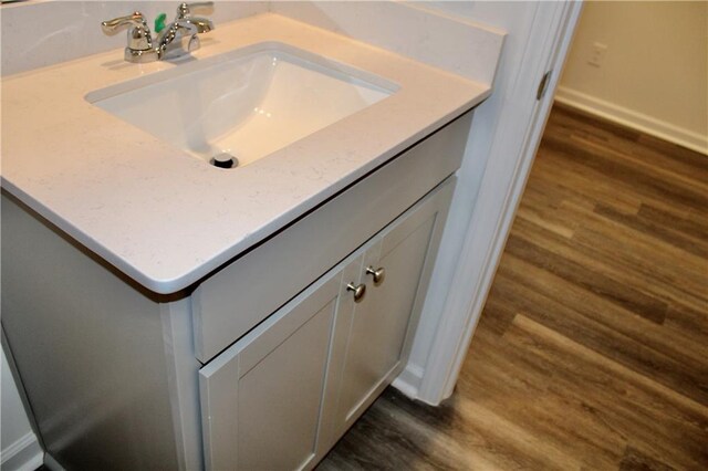 bathroom with hardwood / wood-style flooring and vanity